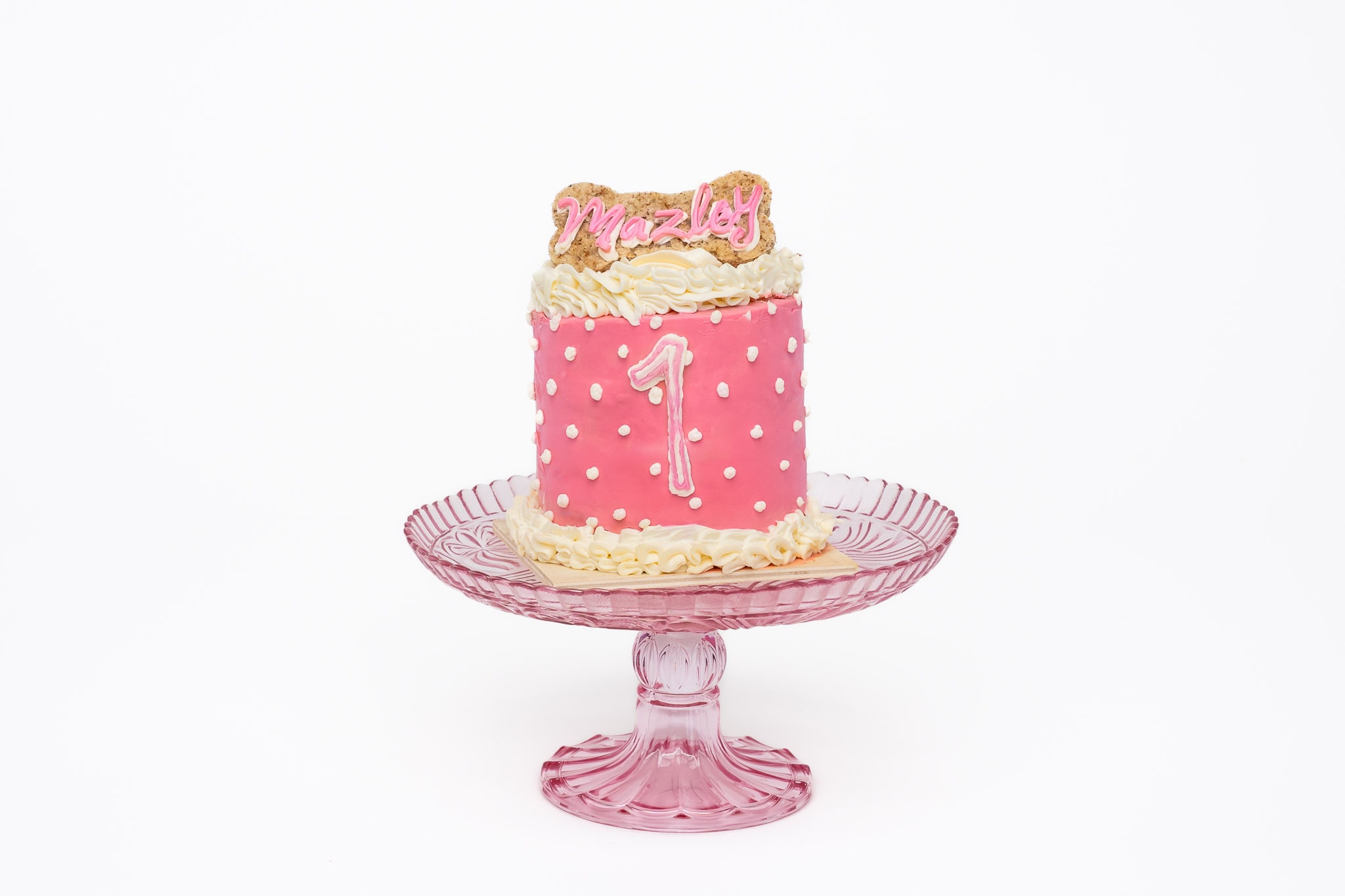 Studio portrait of a Puppy's first birthday cake handmade by a baker in Calgary